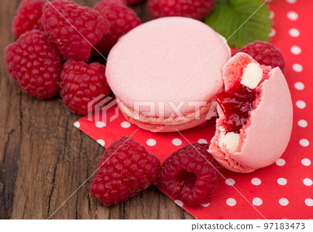 Macaroon with raspberries cookies on a wooden background Macaroon with raspberries cookies on a wooden background 97183473