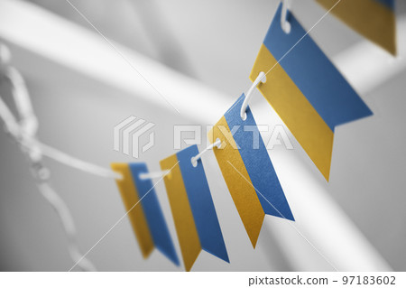 A garland of Ukraine national flags on an abstract blurred background A garland of Ukraine national flags on an abstract blurred background 97183602