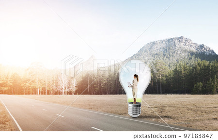 Businesswoman inside light bulb 97183847