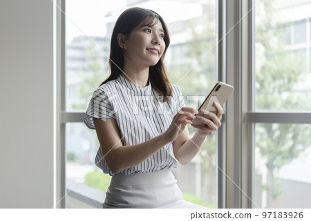 A young woman with a smartphone 97183926