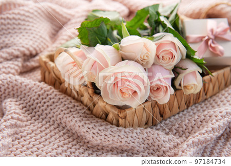 Tray with  bouquet of beautiful pink roses and gift box on  bed. 97184734