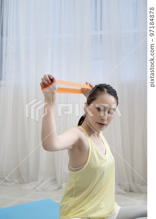 woman doing rubber band training woman doing rubber band training 97184878