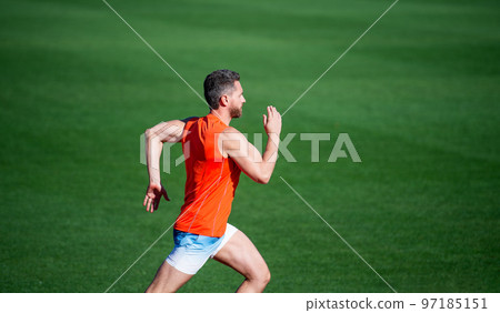 sportsman guy in sportswear run fast sprinting on running track, speed sportsman guy in sportswear run fast sprinting on running track, speed 97185151