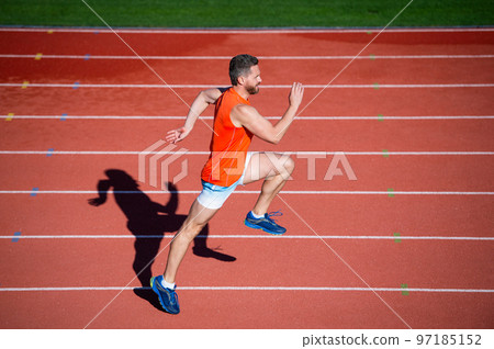 challenge and competition. marathon speed. sprinter. energetic man on running track. challenge and competition. marathon speed. sprinter. energetic man on running track. 97185152