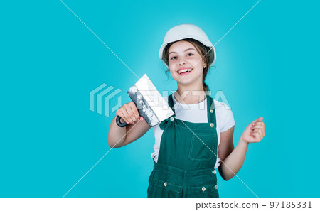 After the work is done. future engineer. happy kid use spatula repairing tool. building construction site. child architect worker. labor day concept. childhood development. teenager girl assistant 97185331