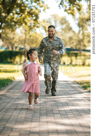 Dad and daughter having fun and running in the park Dad and daughter having fun and running in the park 97185701