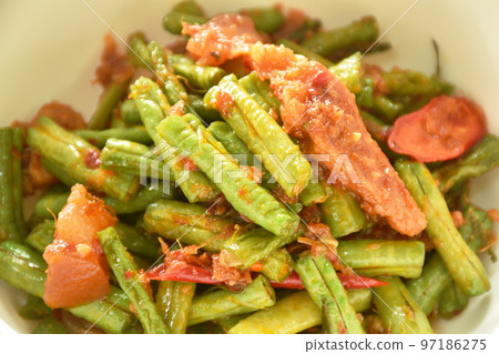 spicy stir fried slice yard long bean with fat pork in curry sauce on bowl 97186275