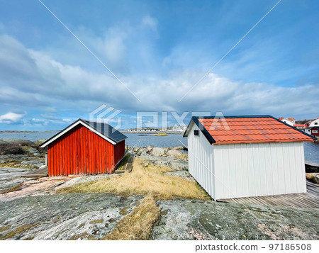 A view of red wooden houses on Vrango Archipelago island . A view of red wooden houses on Vrango Archipelago island . 97186508