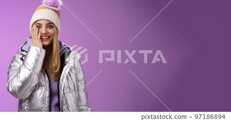 Delighted amused tender blond girlfriend fool around look playful playing snowballs touch cheek astonished feel dream come true enjoying vacation winter holidays boyfriend, standing purple background Delighted amused tender blond girlfriend fool around look playful playing snowballs touch cheek astonished feel dream come true enjoying vacation winter holidays boyfriend, standing purple background 97186894