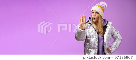 Wow slow down wait sec. Displeased freak-out bothered blond girl raise hand stop enough prohibition gesture shaking head negatively, declining terrible idea not give permission, purple background 97186967