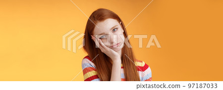 Indifferent careless sleepy redhead silly female student lean palm looking bored uninterested listen lame stories wanna escape standing exhausted lacking interest, posing orange background 97187033