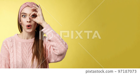 Girl looking through circle from hand amazed, excited folding lips amused and thrilled of awesome incredible promotion, holding okay over eye, seeing good opportunity standing intrigued, interested Girl looking through circle from hand amazed, excited folding lips amused and thrilled of awesome incredible promotion, holding okay over eye, seeing good opportunity standing intrigued, interested 97187073