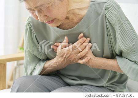 Elderly woman with chest pain at home Elderly woman with chest pain at home 97187103