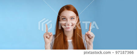 Cheerful curious amused happy entertained redhead pretty girl gazing pointing up smiling approval like interesting product watching perfomance enjoy cool holiday promos, standing blue background Cheerful curious amused happy entertained redhead pretty girl gazing pointing up smiling approval like interesting product watching perfomance enjoy cool holiday promos, standing blue background 97187366