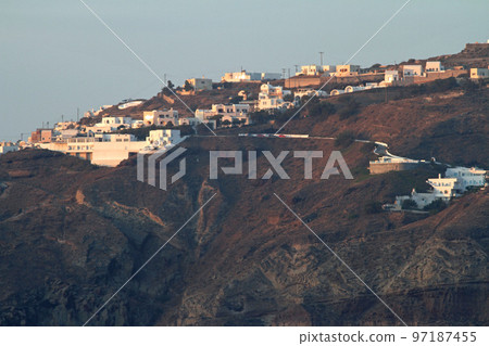 A row of white houses built on the cliffs of Santorini A row of white houses built on the cliffs of Santorini 97187455