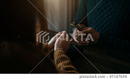 Asian men and women hands praying to god with the bible. Pray for god blessing. Religious beliefs Christian life crisis prayer to god. Asian men and women hands praying to god with the bible. Pray for god blessing. Religious beliefs Christian life crisis prayer to god. 97187649