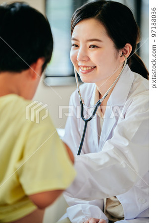 Young female doctor examining with a stethoscope on her stomach 97188036