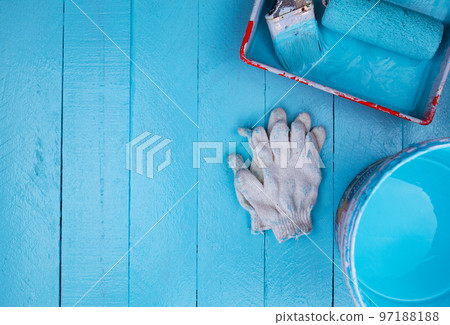 Paint brush in color tray and paint bucket,White glove on blue wooden background 97188188