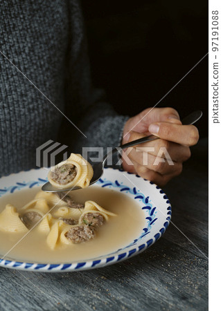 man eating escudella de Nadal typical of Catalonia man eating escudella de Nadal typical of Catalonia 97191088