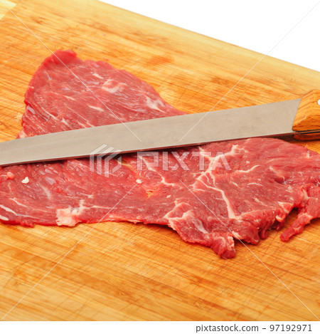 Clean very fresh red raw cow meat and a sharp knife, cutting board and isolated white background Clean very fresh red raw cow meat and a sharp knife, cutting board and isolated white background 97192971