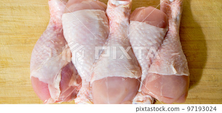 Fresh uncooked chicken meat drumsticks pieces, baget ready to cook 97193024