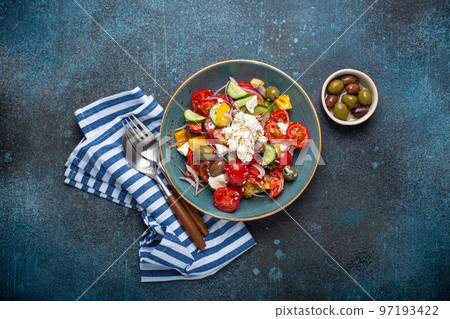 Greek salad with feta cheese, vegetables, olives in blue bowl on concrete background 97193422