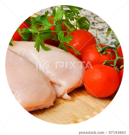 Fresh uncooked chicken meat breast pieces, ready to cook, with tomato and parsley 97193663