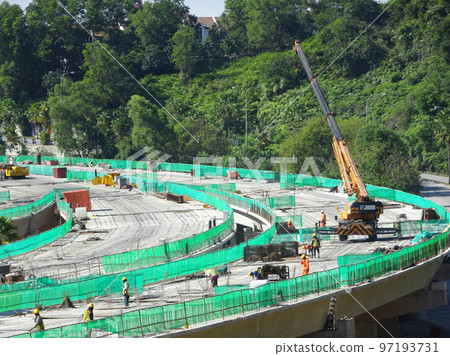 SELANGOR, MALAYSIA -JULY 6, 2022: An elevated road is under construction. Reinforced concrete is used for the structure. Construction is done in stages according to the sequence of works. SELANGOR, MALAYSIA -JULY 6, 2022: An elevated road is under construction. Reinforced concrete is used for the structure. Construction is done in stages according to the sequence of works. 97193731