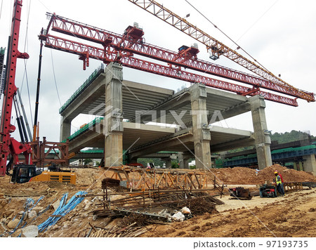 SELANGOR, MALAYSIA -JULY 6, 2022: An elevated road is under construction. Reinforced concrete is used for the structure. Construction is done in stages according to the sequence of works. SELANGOR, MALAYSIA -JULY 6, 2022: An elevated road is under construction. Reinforced concrete is used for the structure. Construction is done in stages according to the sequence of works. 97193735