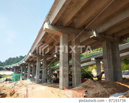SELANGOR, MALAYSIA -JULY 6, 2022: An elevated road is under construction. Reinforced concrete is used for the structure. Construction is done in stages according to the sequence of works. SELANGOR, MALAYSIA -JULY 6, 2022: An elevated road is under construction. Reinforced concrete is used for the structure. Construction is done in stages according to the sequence of works. 97193736