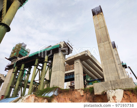 SELANGOR, MALAYSIA -JULY 6, 2022: An elevated road is under construction. Reinforced concrete is used for the structure. Construction is done in stages according to the sequence of works. SELANGOR, MALAYSIA -JULY 6, 2022: An elevated road is under construction. Reinforced concrete is used for the structure. Construction is done in stages according to the sequence of works. 97193738