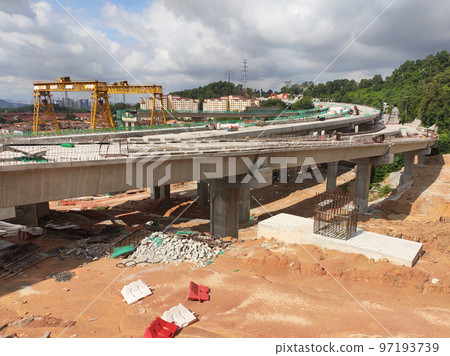 SELANGOR, MALAYSIA -JULY 6, 2022: An elevated road is under construction. Reinforced concrete is used for the structure. Construction is done in stages according to the sequence of works. SELANGOR, MALAYSIA -JULY 6, 2022: An elevated road is under construction. Reinforced concrete is used for the structure. Construction is done in stages according to the sequence of works. 97193739