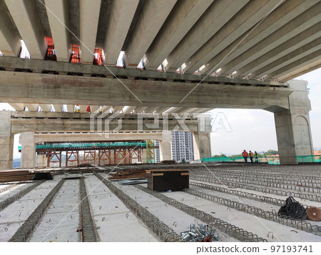 SELANGOR, MALAYSIA -JULY 6, 2022: An elevated road is under construction. Reinforced concrete is used for the structure. Construction is done in stages according to the sequence of works. SELANGOR, MALAYSIA -JULY 6, 2022: An elevated road is under construction. Reinforced concrete is used for the structure. Construction is done in stages according to the sequence of works. 97193741