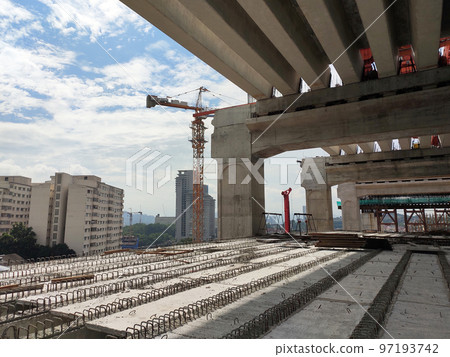 SELANGOR, MALAYSIA -JULY 6, 2022: An elevated road is under construction. Reinforced concrete is used for the structure. Construction is done in stages according to the sequence of works. SELANGOR, MALAYSIA -JULY 6, 2022: An elevated road is under construction. Reinforced concrete is used for the structure. Construction is done in stages according to the sequence of works. 97193742