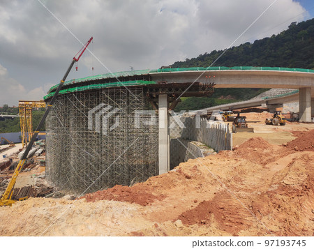 SELANGOR, MALAYSIA -JULY 6, 2022: An elevated road is under construction. Reinforced concrete is used for the structure. Construction is done in stages according to the sequence of works. SELANGOR, MALAYSIA -JULY 6, 2022: An elevated road is under construction. Reinforced concrete is used for the structure. Construction is done in stages according to the sequence of works. 97193745