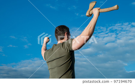 back view of free man with axe. man hold ax. brutal man on sky background 97194670