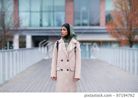 Young multiracial woman standing in a city bridge. 97194762