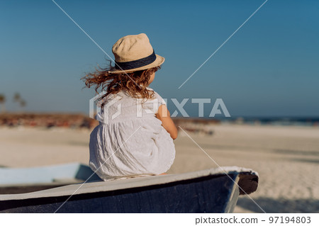 Rear view of little girl looking at the sea. 97194803