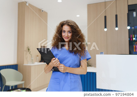 Portrait of dentist nurse posing at reception on private dental clinic. Portrait of dentist nurse posing at reception on private dental clinic. 97194804