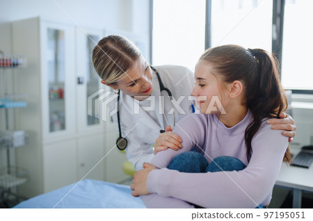 Close-up of doctor supporting teenage girl in her ambulance office. Close-up of doctor supporting teenage girl in her ambulance office. 97195051
