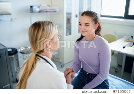 Young woman doctor examining teenage girl in her ambulance. 97195065