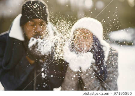 People walks outside. Winter day. African couple People walks outside. Winter day. African couple 97195890