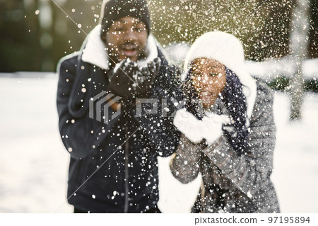 People walks outside. Winter day. African couple People walks outside. Winter day. African couple 97195894