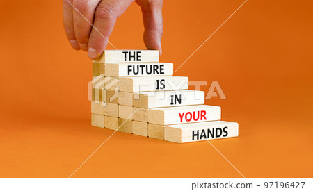 The future is in your hands symbol. Concept words The future is in your hands on wooden blocks on a beautiful orange table orange background. Businessman hand. Business future in your hands concept. The future is in your hands symbol. Concept words The future is in your hands on wooden blocks on a beautiful orange table orange background. Businessman hand. Business future in your hands concept. 97196427