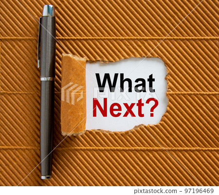 The text 'what next' appearing behind torn brown paper. Beautiful metalic pen. Business concept. 97196469