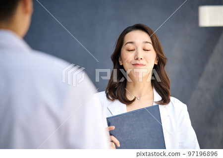 Medical image of men and women in lab coats meeting at the hospital Medical image of men and women in lab coats meeting at the hospital 97196896
