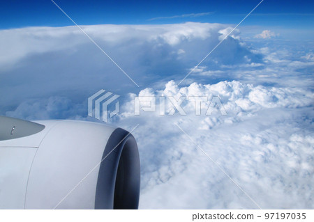 View of the sky and clouds from the airplane porthole View of the sky and clouds from the airplane porthole 97197035