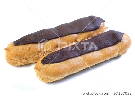 Two eclairs with dark chocolate with custard inside on a white background Two eclairs with dark chocolate with custard inside on a white background 97197052