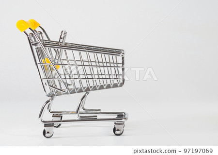 A close-up of an empty shopping cart at the white background with the empty space for texting A close-up of an empty shopping cart at the white background with the empty space for texting 97197069