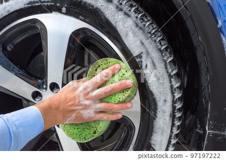 Foam and soap on the car wheel. Washing a car 97197222